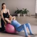 Pregnant woman with a trainer during fitness classes with a ball Pregnant woman with a trainer during fitness classes with a ball