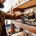 White bearded seller man holding mushroom while working in local shop White bearded seller man holding mushroom while working in local shop